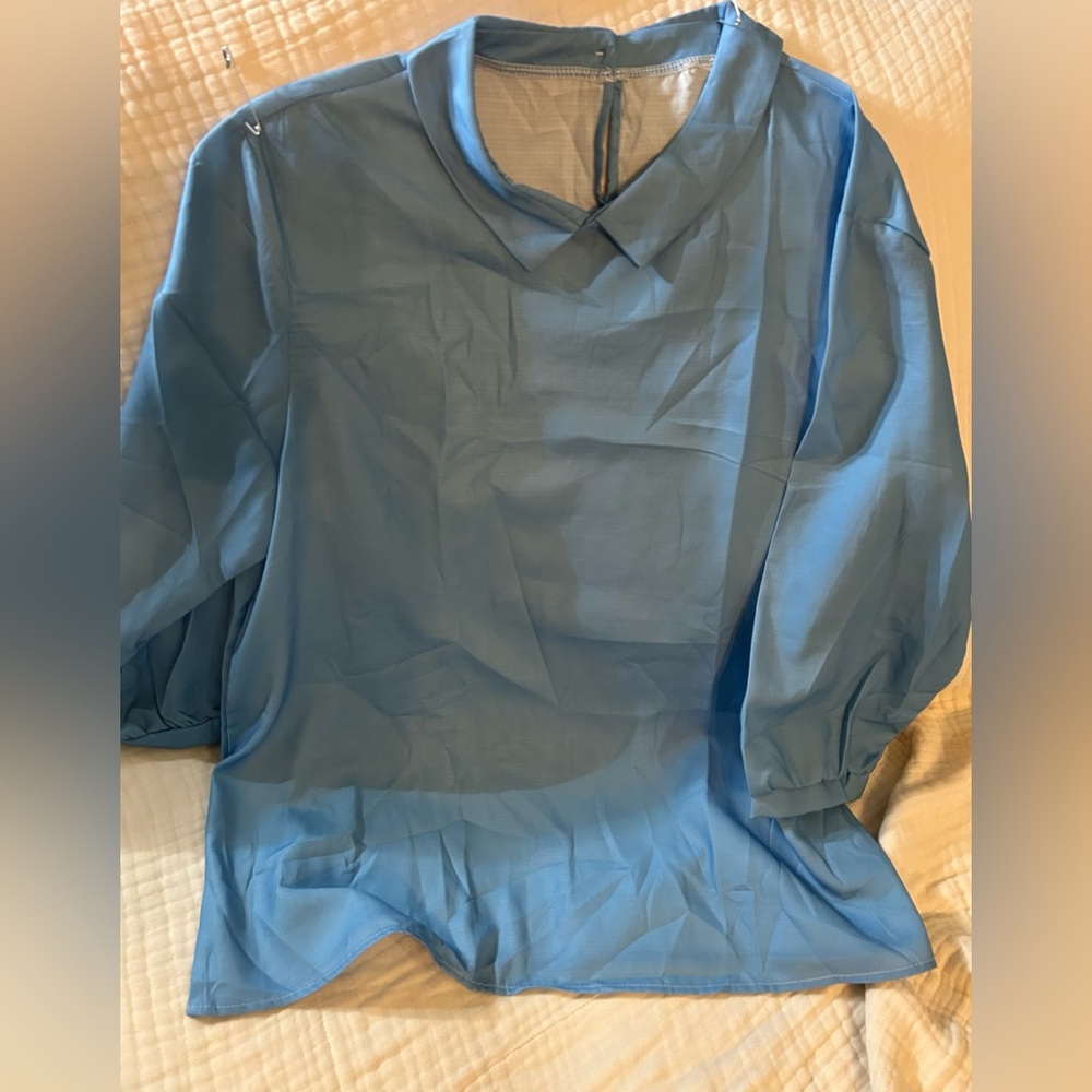 Blue blouse with keyhole back closure. NWOT